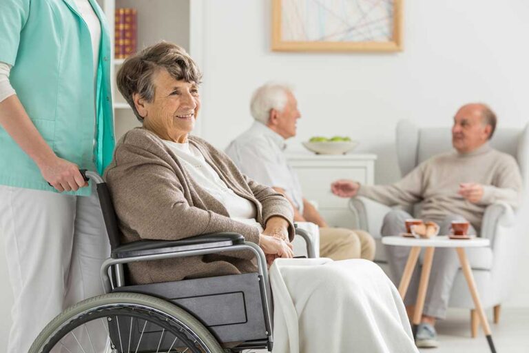 Older adults sharing a balanced meal at a bright assisted living dining table.